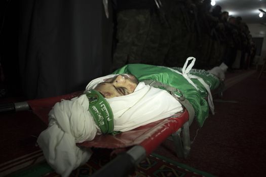 GAZA, Khan Yunis: [Warning: graphic content] The body of Marwan Maarouf is laid to rest by Hamas' Al-Qassam Brigades during a funeral service in Khan Yunis, the Gaza Strip on February 9, 2016. The 27-year-old man was reportedly killed in one of several recent tunnel collapses in southern Gaza since late January.
