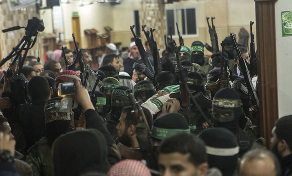 GAZA, Khan Yunis: [Warning: graphic content] Members of Hamas' Al-Qassam Brigades honor the fallen Marwan Maarouf during a funeral service in Khan Yunis, the Gaza Strip on February 9, 2016. The 27-year-old man was reportedly killed in one of several recent tunnel collapses in southern Gaza since late January.