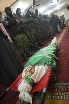 GAZA, Khan Yunis: [Warning: graphic content] The body of Marwan Maarouf is laid to rest by Hamas' Al-Qassam Brigades during a funeral service in Khan Yunis, the Gaza Strip on February 9, 2016. The 27-year-old man was reportedly killed in one of several recent tunnel collapses in southern Gaza since late January.
