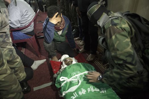 GAZA, Khan Yunis: [Warning: graphic content] A member of Hamas' Al-Qassam Brigades weeps as he honors the fallen Marwan Maarouf during a funeral service in Khan Yunis, the Gaza Strip on February 9, 2016. The 27-year-old man was reportedly killed in one of several recent tunnel collapses in southern Gaza since late January.