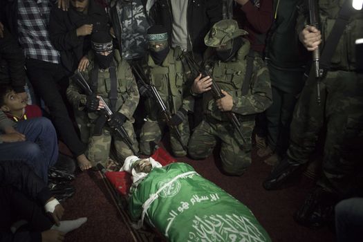 GAZA, Khan Yunis: [Warning: graphic content] Members of Hamas' Al-Qassam Brigades honor the fallen Marwan Maarouf during a funeral service in Khan Yunis, the Gaza Strip on February 9, 2016. The 27-year-old man was reportedly killed in one of several recent tunnel collapses in southern Gaza since late January.
