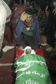 GAZA, Khan Yunis: [Warning: graphic content] A member of Hamas' Al-Qassam Brigades honors the fallen Marwan Maarouf during a funeral service in Khan Yunis, the Gaza Strip on February 9, 2016. The 27-year-old man was reportedly killed in one of several recent tunnel collapses in southern Gaza since late January.