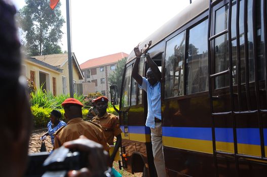 UGANDA, Kampala: David Sejusa flashes his handcuffs as he arrives at military court in Kampala, Uganda on February 9, 2016 where he would be denied bail as his case is adjourned until February 23. Sejusa was jailed after being charged the week previous with charges including absence without official leave, participating in partisan political activities, and insubordination.