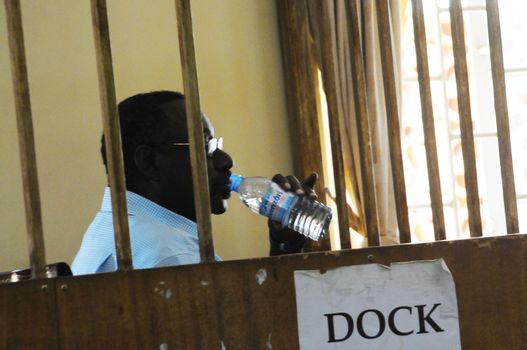 UGANDA, Kampala: David Sejusa waits for his case to be heard at military court in Kampala, Uganda on February 9, 2016. He would then be denied bail and have his case adjourned until February 23. Sejusa was jailed after being charged the week previous with charges including absence without official leave, participating in partisan political activities, and insubordination.