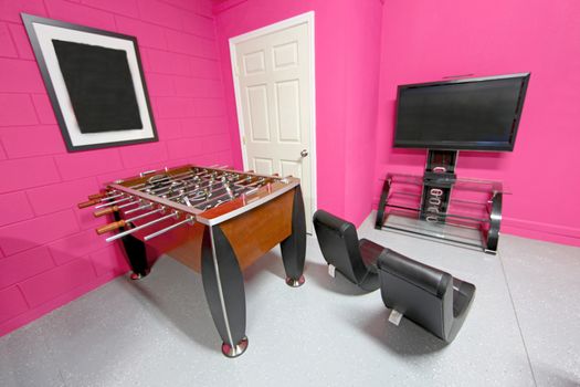 A Games Room with Foosball, TV and Gaming Chairs