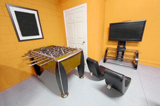 A Games Room with Foosball, TV and Gaming Chairs