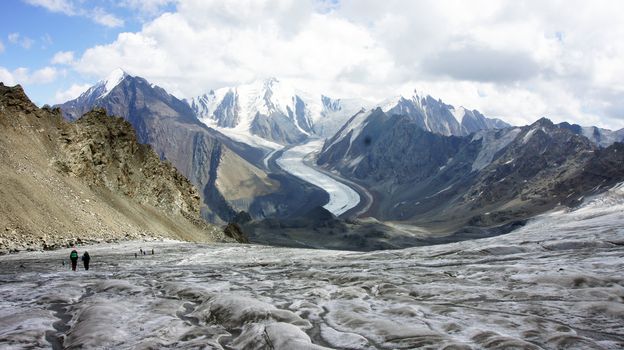 Trekkers at glacier Greater Caucasus Mountain Range, North Osetia, Russia