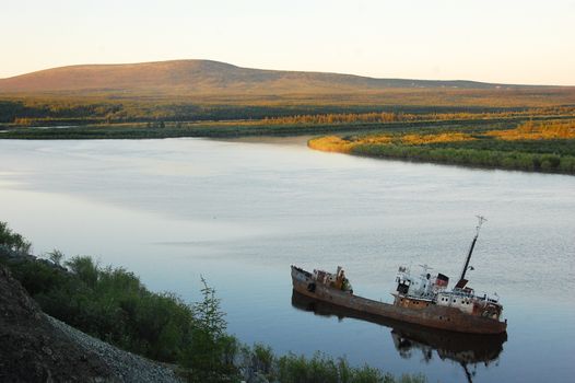 Abandoned sinked ship at Kolyma river,Yakutia region, Russia
