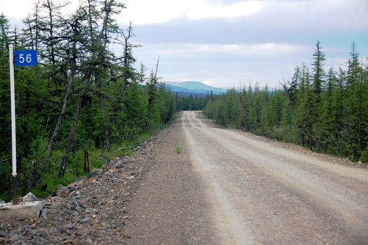 Kilometer post at taiga gravel road, Chukotka, Russia