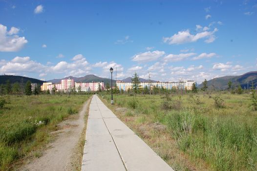 Flagstone pathway at tundra area near town district, Bilibino town, Chukotka, Russia