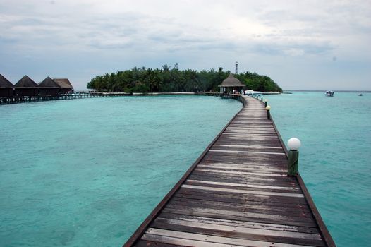 Timber pier at Maldives island resort, Indian Ocean