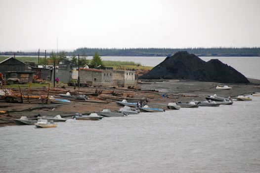 Boats at Kolyma river coast town, Yakutia region, Russia