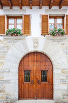 Old rustic wooden door with windows on top