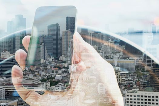 Double exposure of man using smart phone and cityscape background, urban lifestyle and Business technology concept.