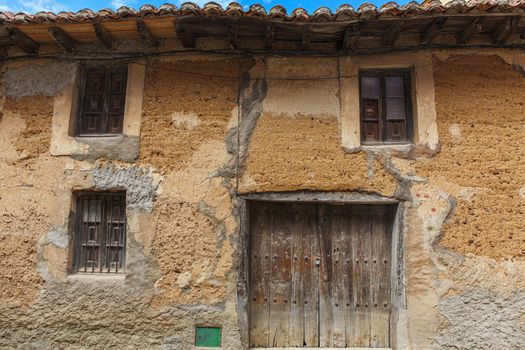 Old rustic wooden door and windows on the wall