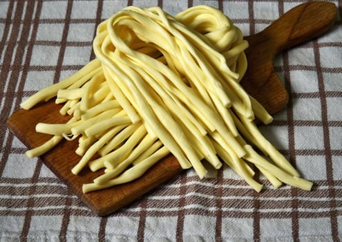 traditional cheese strand on a wooden kitchen board