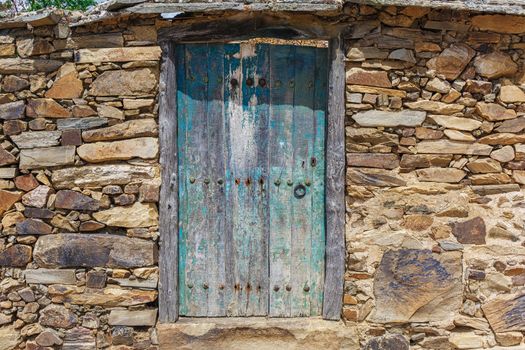 Old rustic wooden door with green paint