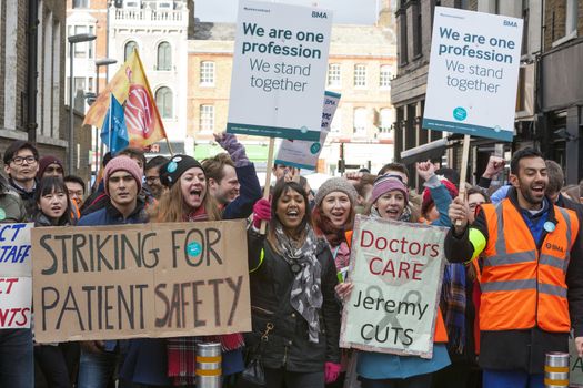 ENGLAND, London: Junior Doctors picket and hold signs during a demonstration outside Royal London Hospital on February 10, 2016, in London. The strike claim's the doctors would be over-worked which would lead to patients being endangered.  