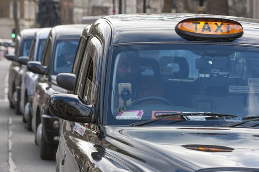 UNITED-KINGDOM, London: Dozens of black cab drivers stage a protest in central London, causing gridlock to Whitehall and Trafalgar Square as taxi drivers hold another protest under the hashtag #Blackcabprotest against competition from app-based taxi services, and especially US company Uber, on February 10, 2016. Since its introduction in Britain, drivers of the city's famous black cabs have argued Uber bypasses local licensing and safety laws and amounts to unfair competition. They have staged a number of high-profile protests, including go-slow demonstrations that have brought traffic in the centre of London from Trafalgar Square to Victoria street.