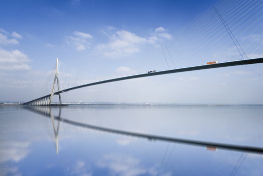 pillar of the bridge "Pont de Normandie" reflected in the Seine river at Le Havre, France