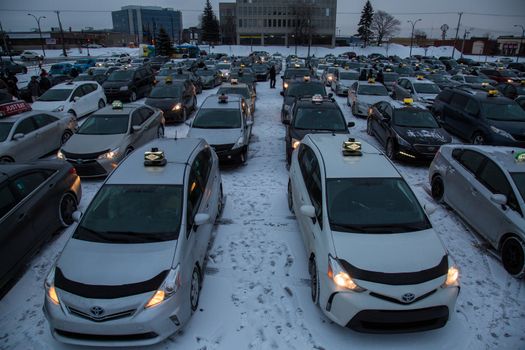 CANADA, Montreal: Taxi's were lined up and parked outside of Trudeau Airport in Montreal, on February 10, 2016, in a show of protest against Uber.Traffic was disrupted at the airport as the taxi drivers hope to force Quebec's government to make a change.