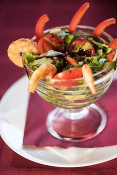 healthy green salad with cooked shrimp and vegetables