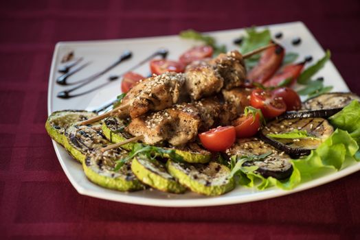 Grilled kebab pork meat with roasted potato and vegetables