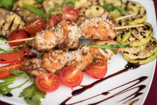Grilled kebab pork meat with roasted potato and vegetables