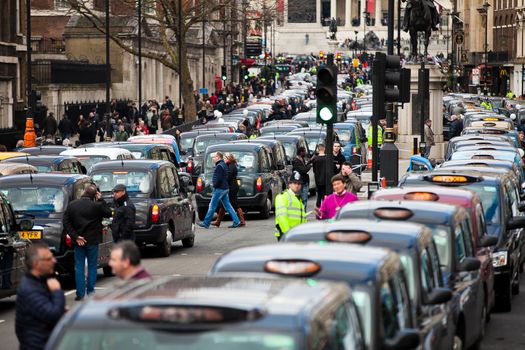 UNITED-KINGDOM, London: Dozens of black cab drivers stage a protest in central London, causing gridlock to Whitehall and Trafalgar Square as taxi drivers hold another protest under the hashtag #Blackcabprotest against competition from app-based taxi services, and especially US company Uber, on February 10, 2016. Since its introduction in Britain, drivers of the city's famous black cabs have argued Uber bypasses local licensing and safety laws and amounts to unfair competition. They have staged a number of high-profile protests, including go-slow demonstrations that have brought traffic in the centre of London from Trafalgar Square to Victoria street.