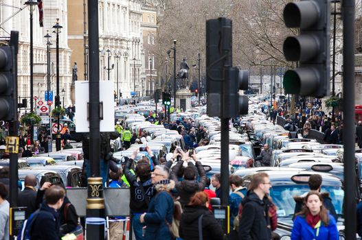 UNITED-KINGDOM, London: Dozens of black cab drivers stage a protest in central London, causing gridlock to Whitehall and Trafalgar Square as taxi drivers hold another protest under the hashtag #Blackcabprotest against competition from app-based taxi services, and especially US company Uber, on February 10, 2016. Since its introduction in Britain, drivers of the city's famous black cabs have argued Uber bypasses local licensing and safety laws and amounts to unfair competition. They have staged a number of high-profile protests, including go-slow demonstrations that have brought traffic in the centre of London from Trafalgar Square to Victoria street.