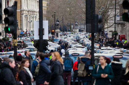 UNITED-KINGDOM, London: Dozens of black cab drivers stage a protest in central London, causing gridlock to Whitehall and Trafalgar Square as taxi drivers hold another protest under the hashtag #Blackcabprotest against competition from app-based taxi services, and especially US company Uber, on February 10, 2016. Since its introduction in Britain, drivers of the city's famous black cabs have argued Uber bypasses local licensing and safety laws and amounts to unfair competition. They have staged a number of high-profile protests, including go-slow demonstrations that have brought traffic in the centre of London from Trafalgar Square to Victoria street.