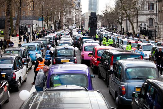 UNITED-KINGDOM, London: Dozens of black cab drivers stage a protest in central London, causing gridlock to Whitehall and Trafalgar Square as taxi drivers hold another protest under the hashtag #Blackcabprotest against competition from app-based taxi services, and especially US company Uber, on February 10, 2016. Since its introduction in Britain, drivers of the city's famous black cabs have argued Uber bypasses local licensing and safety laws and amounts to unfair competition. They have staged a number of high-profile protests, including go-slow demonstrations that have brought traffic in the centre of London from Trafalgar Square to Victoria street.