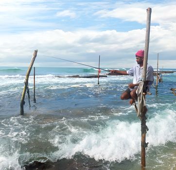 Local fisherman on stick in indian ocean, Sri lanka