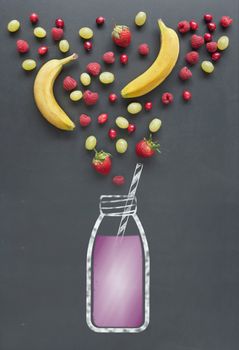 Fresh fruit including berries, cranberrries and raspberries next to a drawing of a smoothie on a chalkboard 