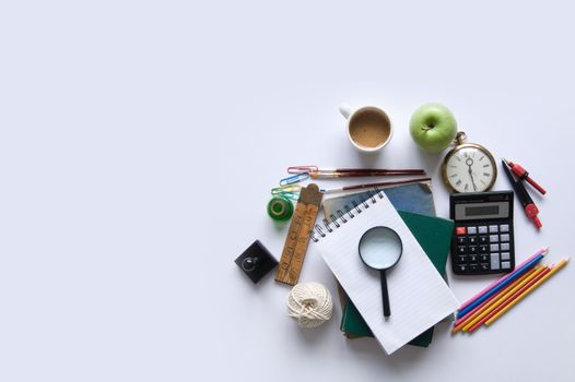 Various stationery objects on a white table with space 