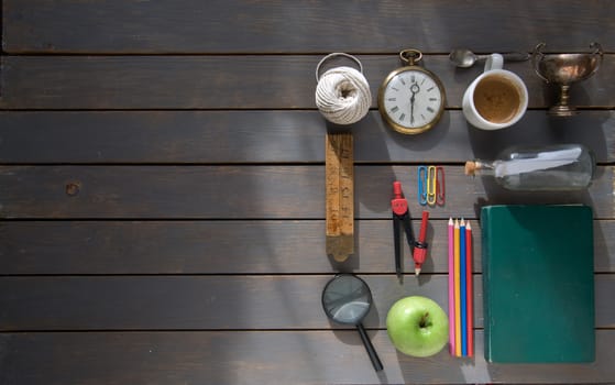 Various items vintage stationery laid out on a wooden background with space 