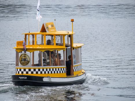 Victoria, British Columbia, Canada- June 21, 2012: A water taxi takes passengers across the Inner Harbour to Victoria West in this beautiful Canadian city in the Pacific Northwest.