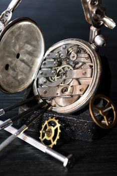 Hour workshop. Vintage still life with ancient silver pocket watch