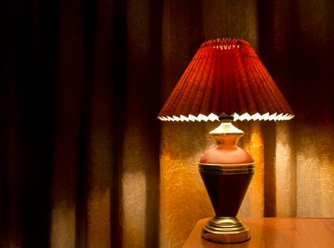 old fashion table lamp on the table, yellow curtains