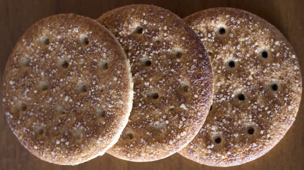 sugar cookies with cinnamon on dark brown table