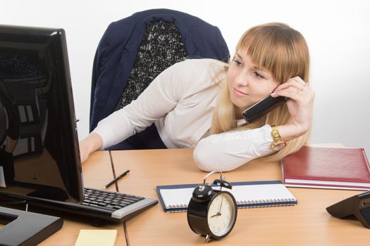 young beautiful business woman sitting at office desk working, isolated on white background