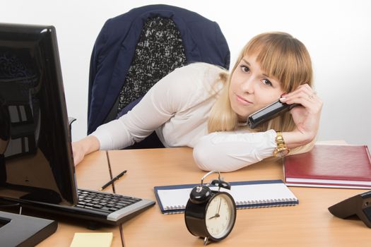 young beautiful business woman sitting at office desk working, isolated on white background