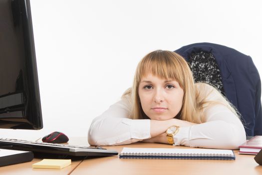 young beautiful business woman sitting at office desk working, isolated on white background