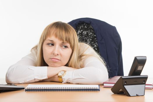 young beautiful business woman sitting at office desk working, isolated on white background