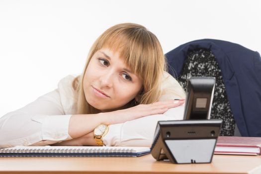 young beautiful business woman sitting at office desk working, isolated on white background