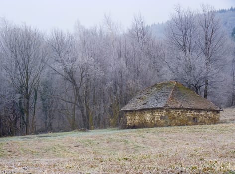 Old stone farmhouse barn on the mountain, the beginning of winter