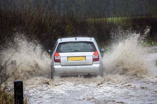 Driving through floodwater on a country road in North Yorkshire in the United Kingdom.