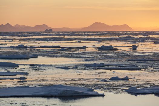 Midnight Sun and sea ice of the coast of eastern Greenland.