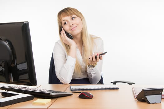 young beautiful business woman sitting at office desk working, isolated on white background