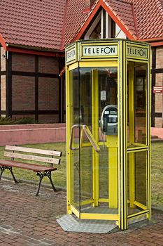 Yellow phone booth on the street